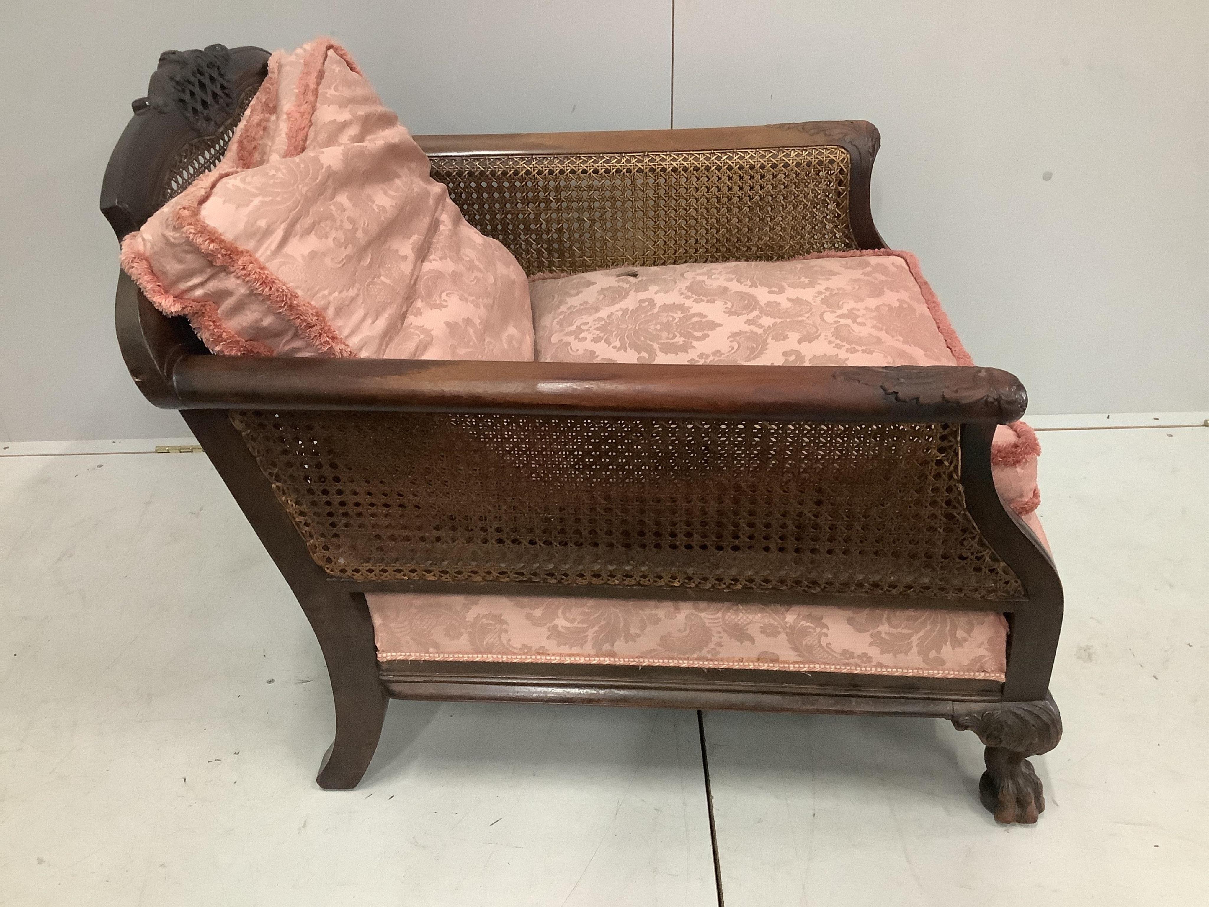 A 1930's mahogany three piece Bergere suite, with double caned arms and single caned backs. Condition - some fading with small damages to the caning